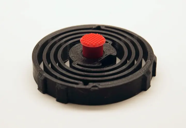 3D printed sping with red nub